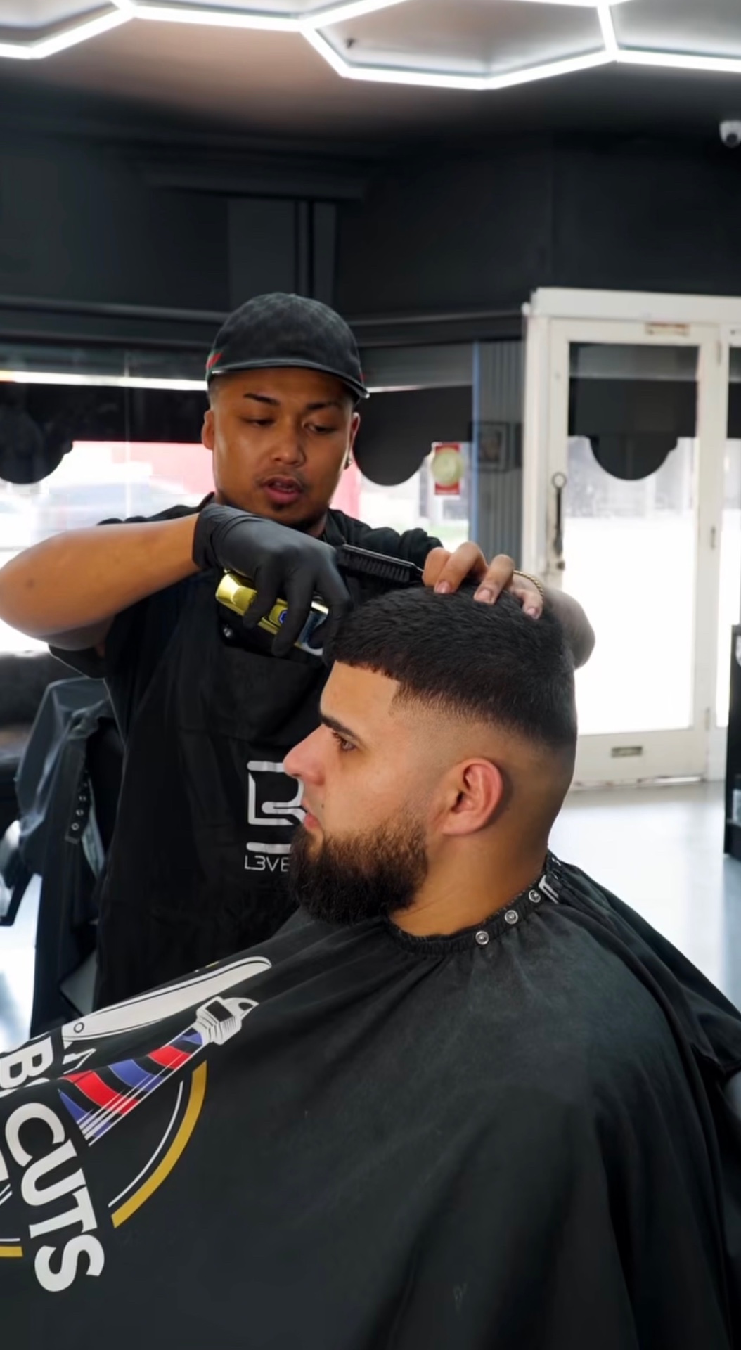 Barber cutting hair using Valet Vault queue management and booking software